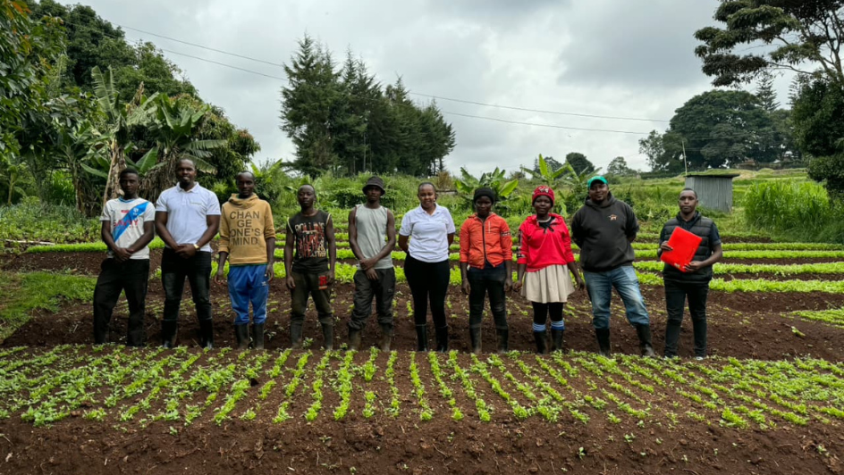 African youth receiving a farmer empowerment training in a rural field.