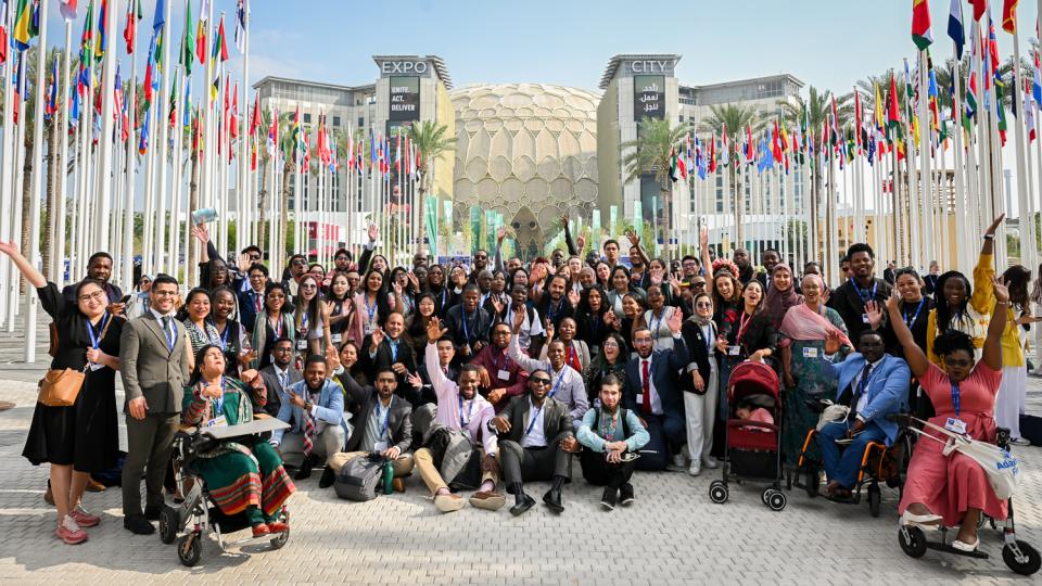 IYCDP graduates pose for a group photo during COP28 at Expo City Dubai.