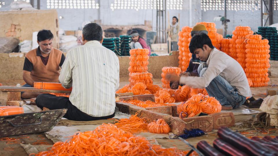 Workers sort glass bangles at a factory in Firozabad, Uttar Pradesh, India.