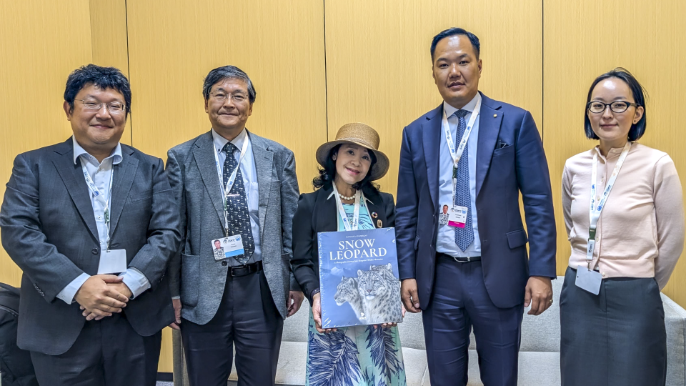 people posing for photo with book