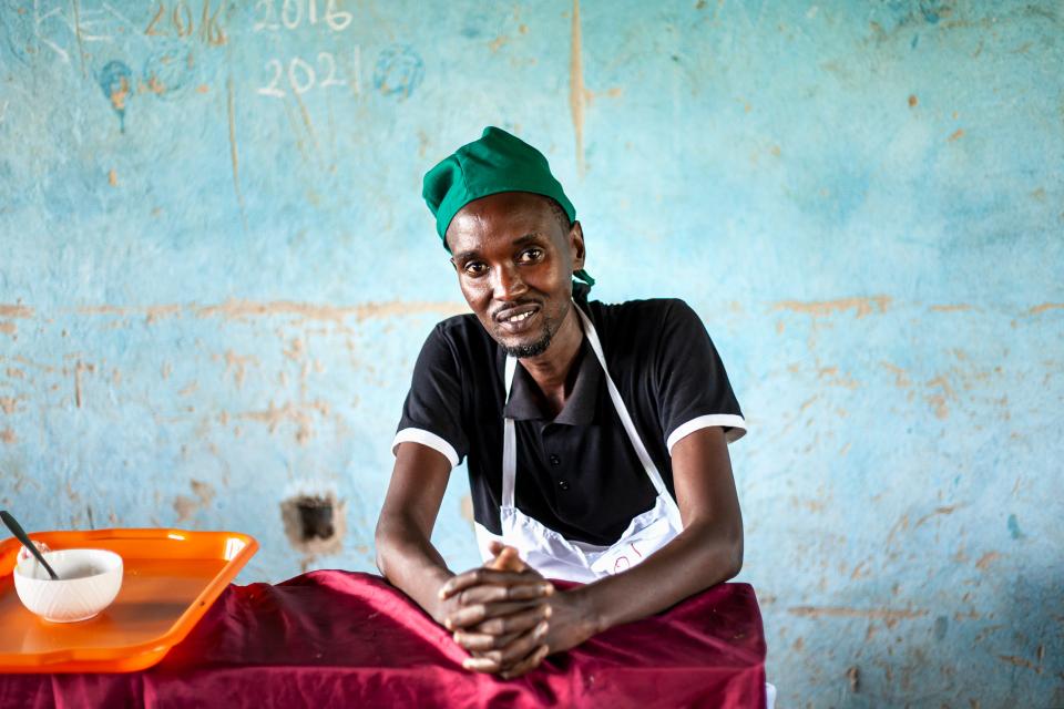 A refugee chef about to take a culinary exam with the goal of receiving an official certification and ultimately getting matched with a Ugandan employer. 