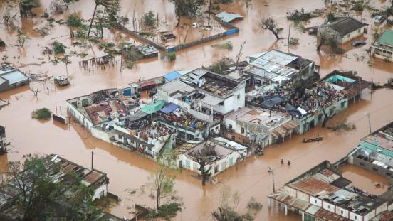 People take refuge on the roofs of buildings following flooding caused by Cyclone Idai in Mozambique.