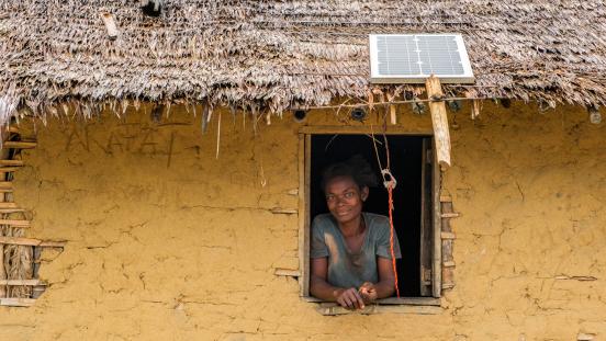 A woman in a house with a solar panel.