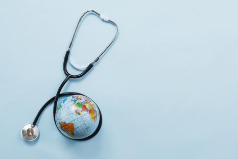 A picture of a globe and a stethoscope signifying the concept of global health. 