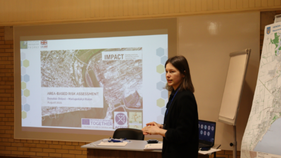 UNU-EHS alumna Nataliia Makaruk giving a presentation at IMPACT Initiatives