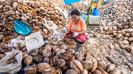 A woman working on coconuts