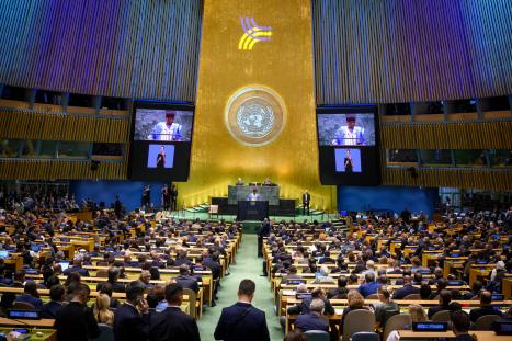 Philemon Yang (at podium and on screens), President of the seventy-ninth session of the United Nations General Assembly, addresses the opening of the Summit of the Future.
