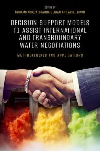 Book cover depicting a handshake in front of water dam