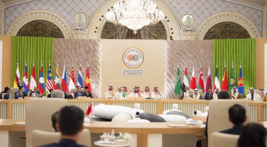 Formal diplomatic event hosted in room decorated in gold and white