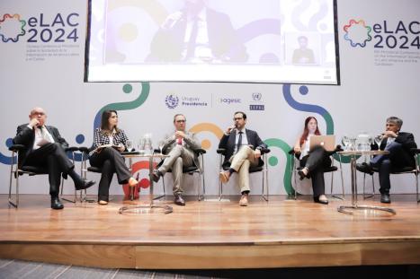 six individuals seated as part of panel discussion