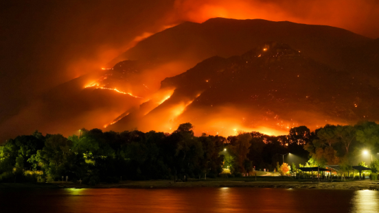 A wildfire burns on a mountainside.