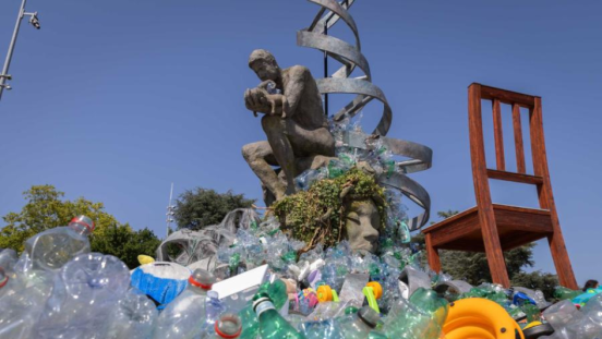 Discarded plastic is placed in front of a statue in Geneva, Switzerland. 
