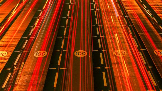 Red car tail light streaks in Dubai