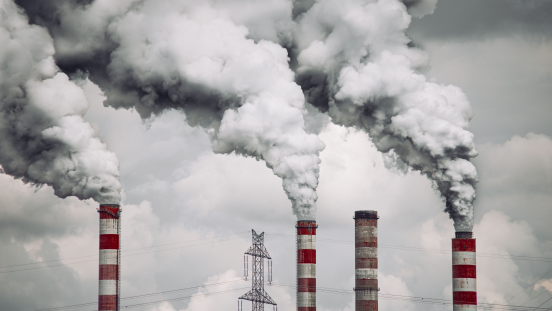 Industrial chimneys emitting clouds of smoke