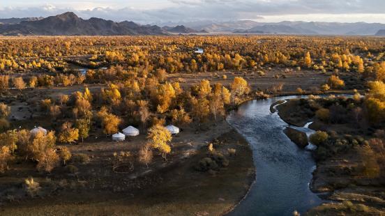 mongolian landscape with yurts and river