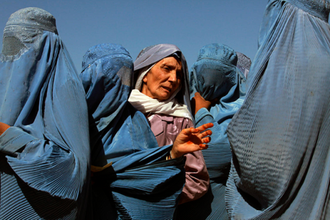 Afghan Women line up at the UN World Food Program Distribution Point in Herat, Afghanistan on May 7, 2012.