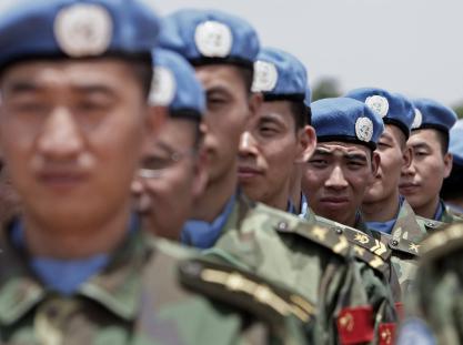 Newly arrived engineers from China serving with the United Nations-African Union Mission in Darfur (UNAMID) stand to attention after arriving in Nyala, South Darfur.