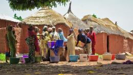 Women collect water from a community well, New Bussa region, NW Nigeria. 