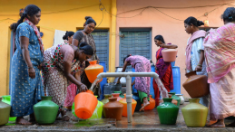 Women filling containers with water from a community pump