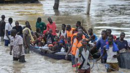 People move through flood waters to reach safety in Nigeria. 