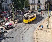 A traditional tram driving on the roads of Porto, Portugal