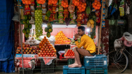 Street Vendor Selling Fruits in Flooded Market. 