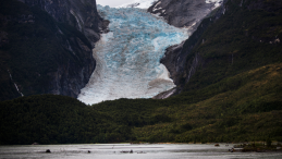 A melting glacier and a river in the forefront.