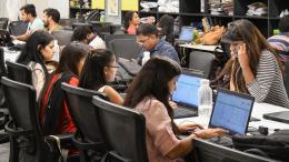 Women and men working in a co-working space in Delhi, India.