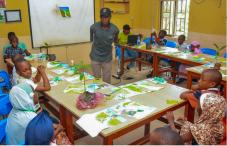 RCE Minna Green Fingers Project in Nigeria — Children in a classroom learning about tree planting 