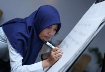 Young Indonesian woman writing