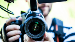 Close-up of a man holding a camera