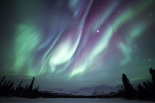 Aurora Borealis over snowy mountains