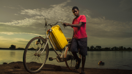 A boy transporting water with a bicycle in Taha