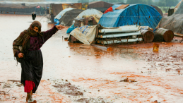 A woman with a headscarf in a flooded camp