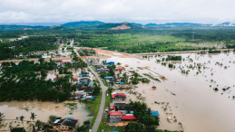 A flooded village in a tropical setting. 