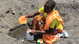 Woman scooping water