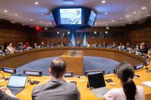 Deputy Secretary-General Amina Mohammed (centre, between flags) meets with Youth Advisory Group on Climate Change.