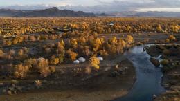Mongolian landscape with river and tents