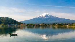 A view of Mount Fuji with a fishing boat on Lake Kawaguchi, Japan.