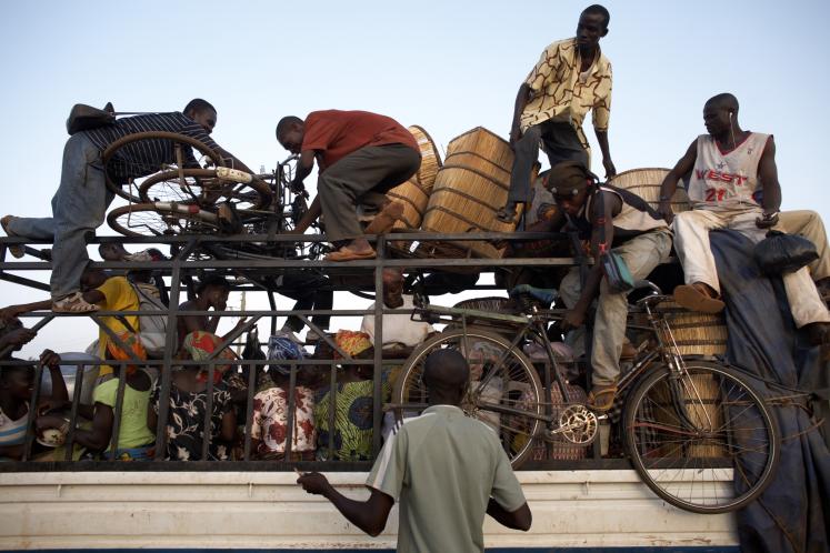 A bus packed with people prepares to leave Nandom, Ghana, for the journey south