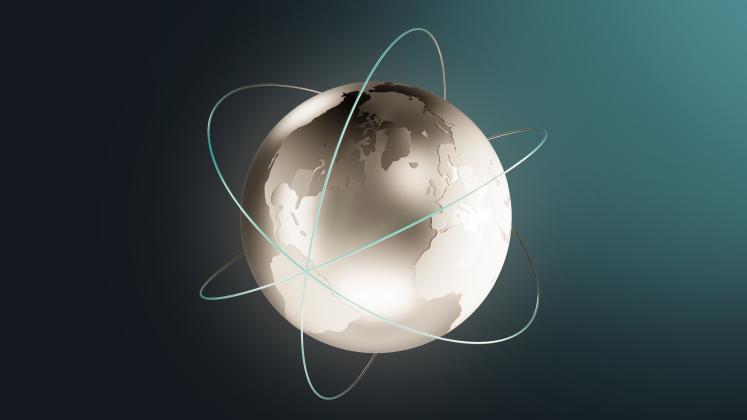 A computer-generated globe encompassed in rings representing signals. 