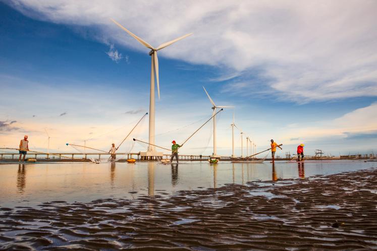 Wind turbines and men fishing