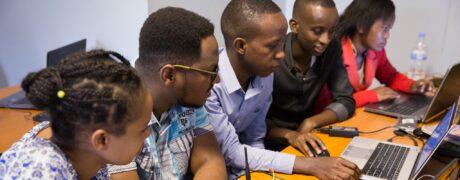 A picture of students looking at a laptop