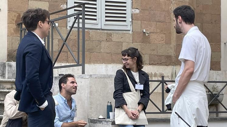 L-R: Mario Alberto Macchioni, Federico Riccio, Cecilia Seri and another participant chat during a coffee break at the 2023 summer school.