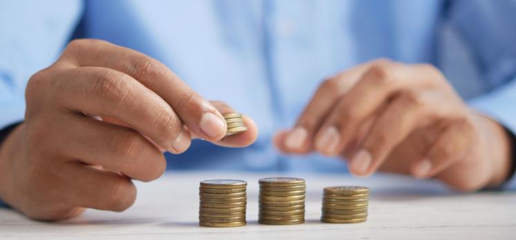 Picture of a person stacking coins