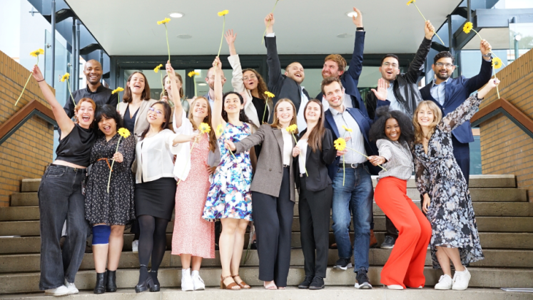 Master's students take a celebratory photo following their graduation. 