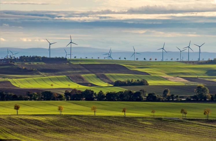 Green fields with wind turbines