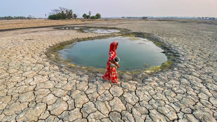 Woman fetching water in arid area of Bangladesh