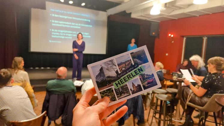 A photo of a postcard saying "positive greetings from Heerlen"