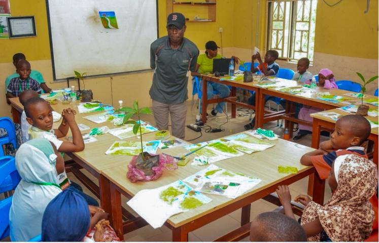 RCE Minna Green Fingers Project in Nigeria — Children in a classroom learning about tree planting
